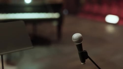 Dynamic Microphone on Stage with Piano Background