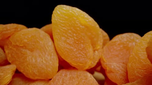 Dried Apricots Are Spread Out in a Large Pile on the Table. Dolly slider extreme close-up.