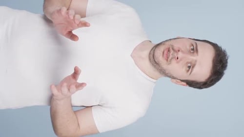 Vertical video of Fear reaction of man looking at camera. Coward man.