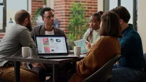 Diverse Team Collaborating on Project in Modern Office