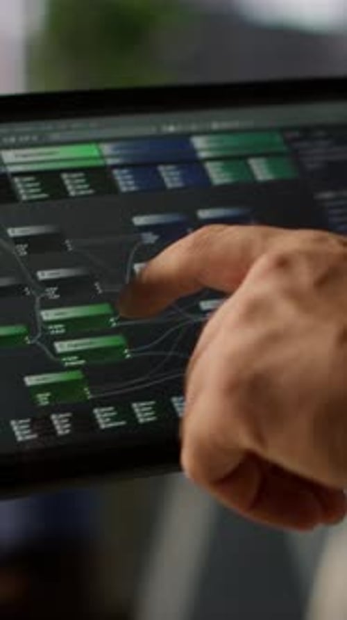 Vertical Video Data Scientist Uses Tablet to Check on Machine Learning Models Close Up