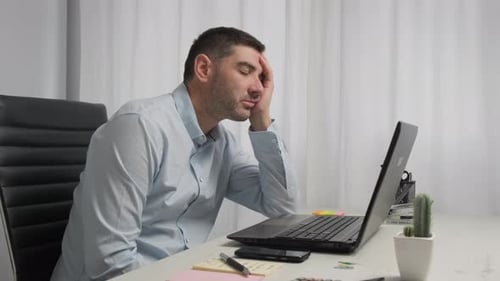 Exhausted Man fell asleep at his office desk from fatigue, then he wake up, Home working