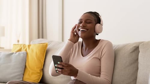 Happy Woman Listening to Music at Home