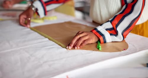 Fashion designer, hands and measure pattern with tape on table, manufacturing