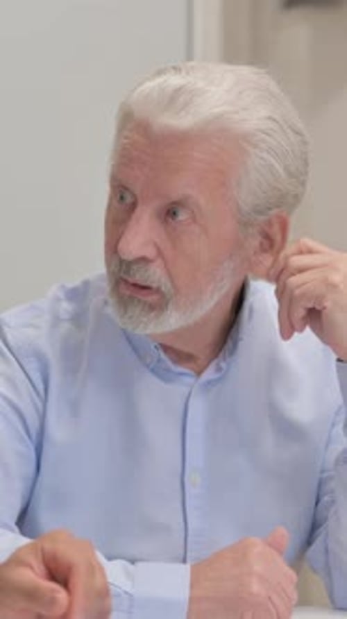 Close up of Old Businessman Talking with Mixed Race Man, vertical video