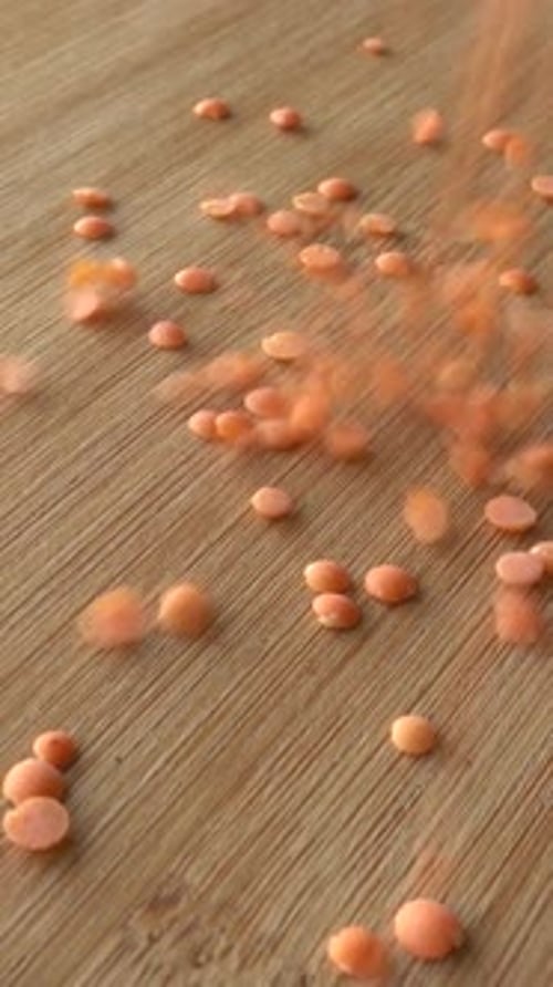 Red Lentils Poured on Wooden Table