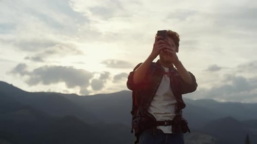 Tourist Take Photo Using Phone Camera On Picturesque Mountains Landscape. Close Up Smiling Hipste...