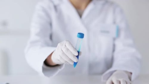 Scientist Holding Test Tube with Blue Liquid
