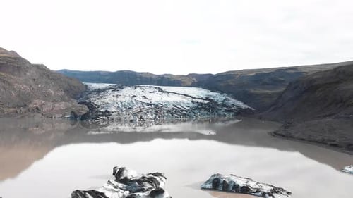 Kayaking in muddy ice moraine lake of Solheimajokull glacier, Iceland.