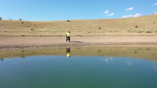 Aerial View Of Man And Woman Walking And Talking Each Other By Lake 2