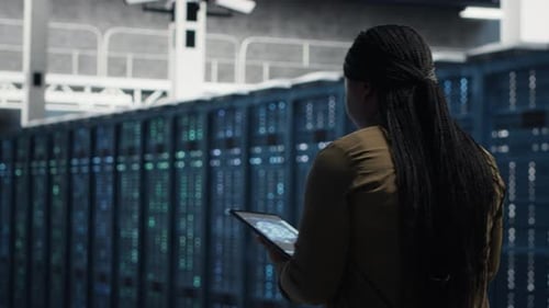 Technician Runs Equipment Checkups with Green Screen Laptop in Data Center