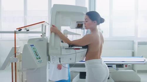 In the Hospital, Side View Shot of Topless Female Patient Undergoing Mammogram Screening Procedure.