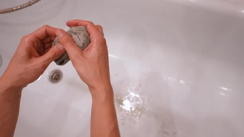 Closeup Highangle View of Unrecognizable Man Washing in Bathroom Dirty Microfiber Cloth From Robot