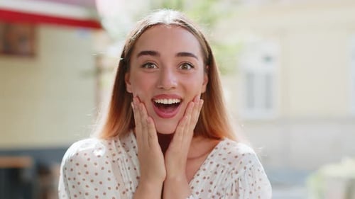 Surprised Woman with Hands on Face