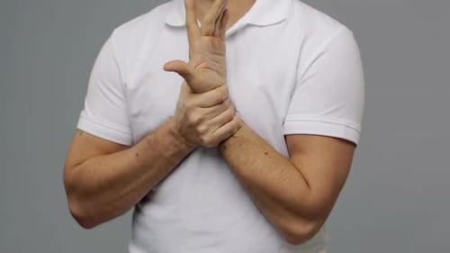 Man Massaging His Wrist in Painful Motion