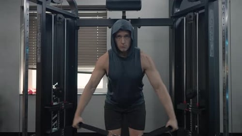 Sportsman in 30s Shoulders Workout, Performing Side Raises Exercise in Cable Cross Over