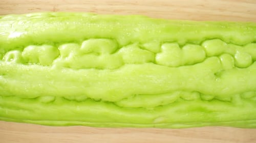 Chinese Bitter Gourd glistens with droplets of water