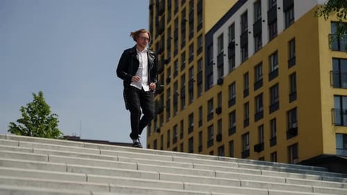 Stylish Man Walking Down City Steps