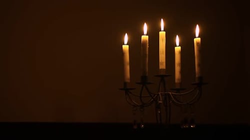 Candelabra with Flickering Candles in Dark Room