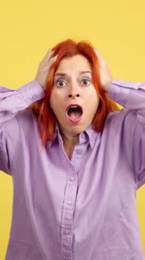 Shocked Woman with Red Hair Reacts in Fear