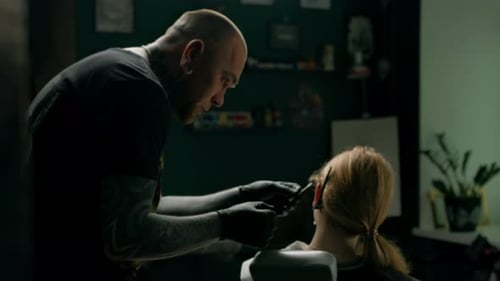 Piercing studio interior - piercing master makes a piercing to a girl, ear piercing