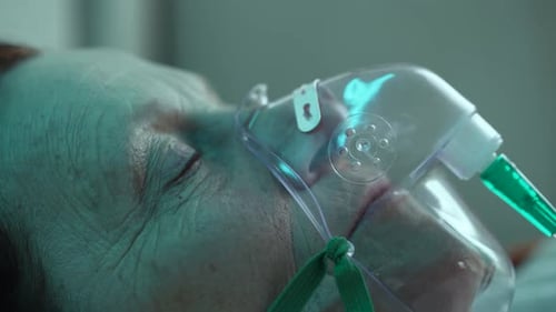 Elderly Woman Wearing Oxygen Mask or CPAP in Hospital or Home