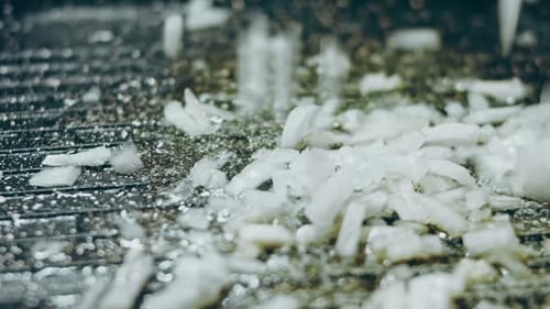 White Fragments Piling on a Dark Surface