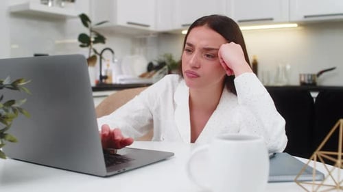 Woman Tired of Working on Laptop at Home