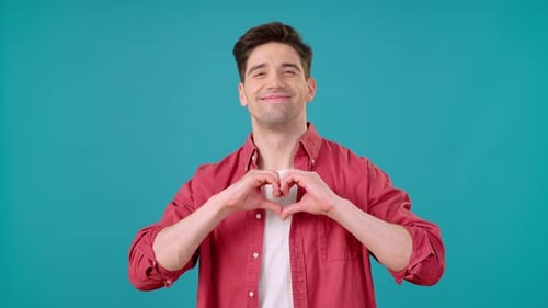 Smiling Man Making Heart Shape with Hands