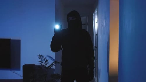 Dark Figure with Flashlight in Blue-Toned Home