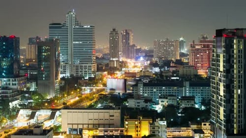 Bangkok Skyline with City Traffic at Night. Time Lapse Aerial