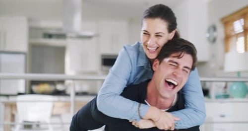 Laughing Couple Piggyback Ride Indoors