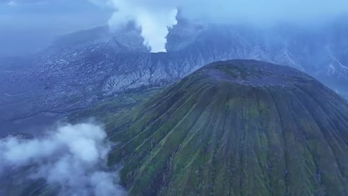 aerial view flying to mount Bromo active volcano above sea of clouds, Java, Indonesia