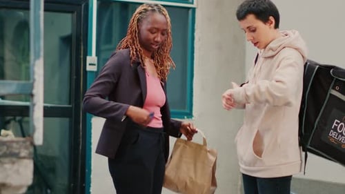 African American Woman Using Credit Card to Pay for Meal Order