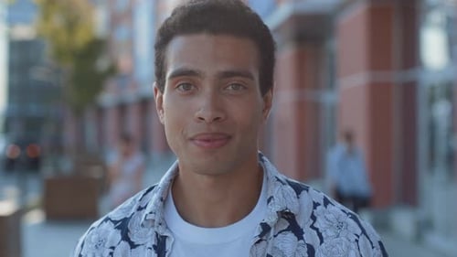 Smiling young man in stylish shirt on city street