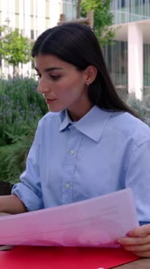 Young Businesswoman Working Online Sitting Outside Over Company Building