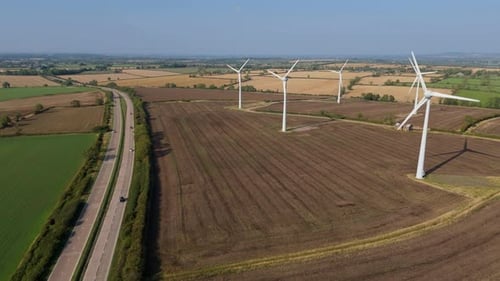 Aerial view of wind turbines and highway, United Kingdom.
