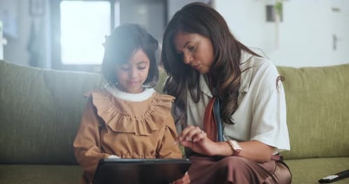 Child and Adult Using Tablet at Home