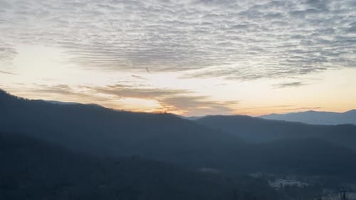 Colorful sunrise in forest with moving clouds timelapse with layers and sunrays