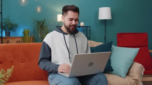 Young Man Freelance Worker Call Center or Support Service Operator Helpline Having Talk with Client