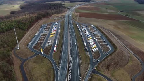 High angle view on a highway parking with many trucks in parking lots, 4k