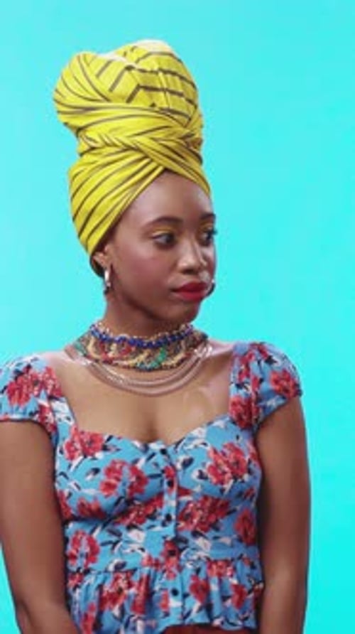 A Stunningly Vibrant Portrait of a Woman Dressed Elegantly in Colorful Attire and Stylish Headwrap