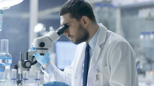 Scientist Using Microscope in Laboratory for Research