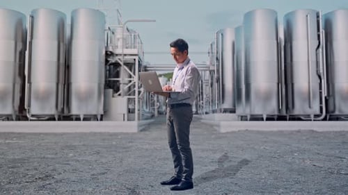 Asia Male Use Laptop at Chemical Plant