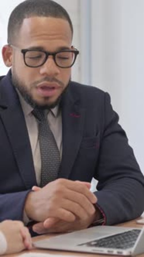 Businessman Talking with Female Worker in Office, vertical video