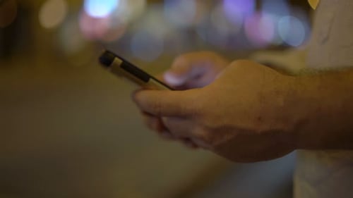 Man Using Smartphone in City at Night Adult