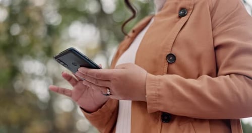 Adult Typing on Smartphone Outside in Urban Setting
