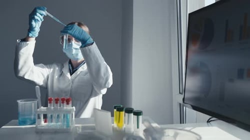 Un científico dedicado lleva a cabo meticulosamente experimentos de vanguardia en un laboratorio moderno