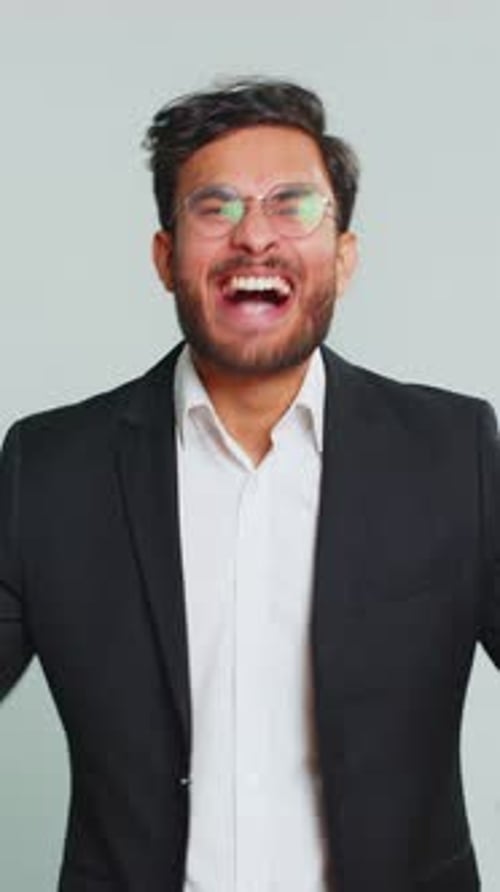 Excited Man Cheering with Fists Pumped in Air