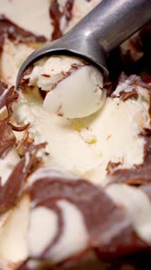 Creamy Ice Cream in Container Covered in Chocolate Concept of Sweet Desserts